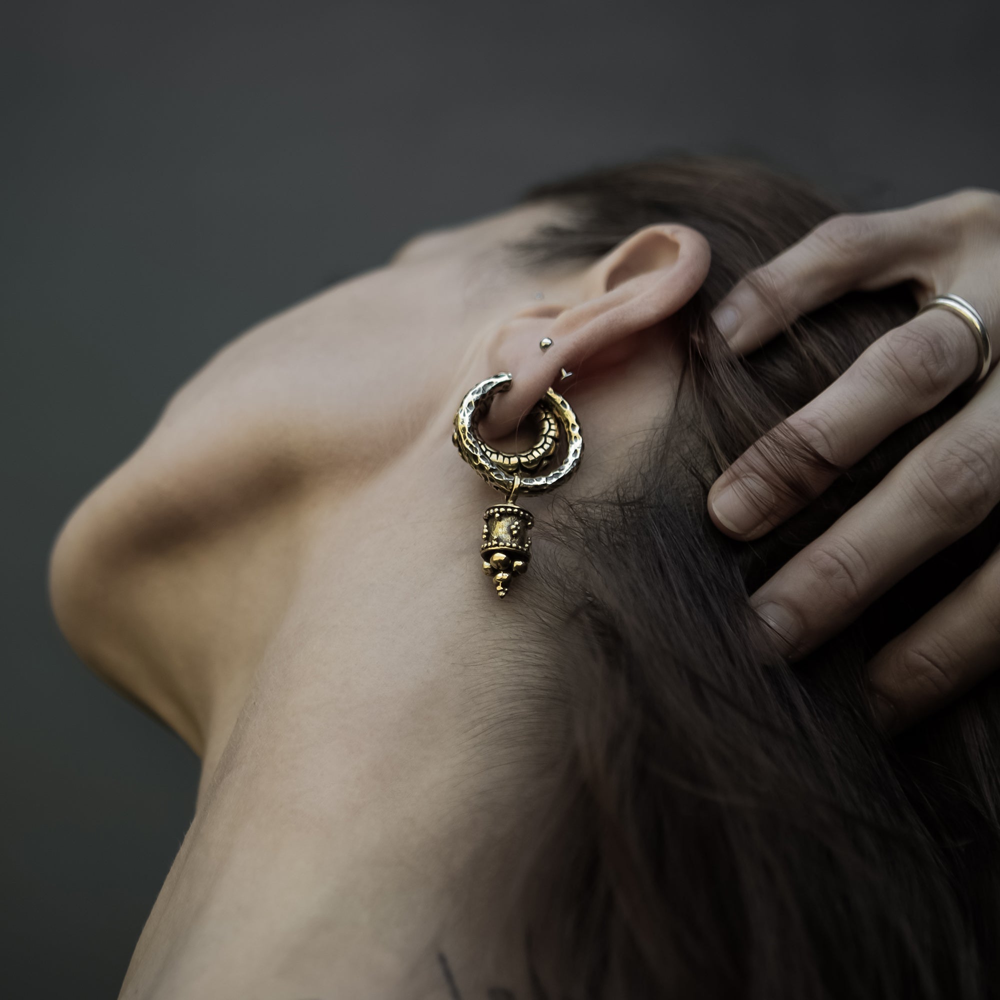 model wearing Afghan Cylinder Clicker Earrings
