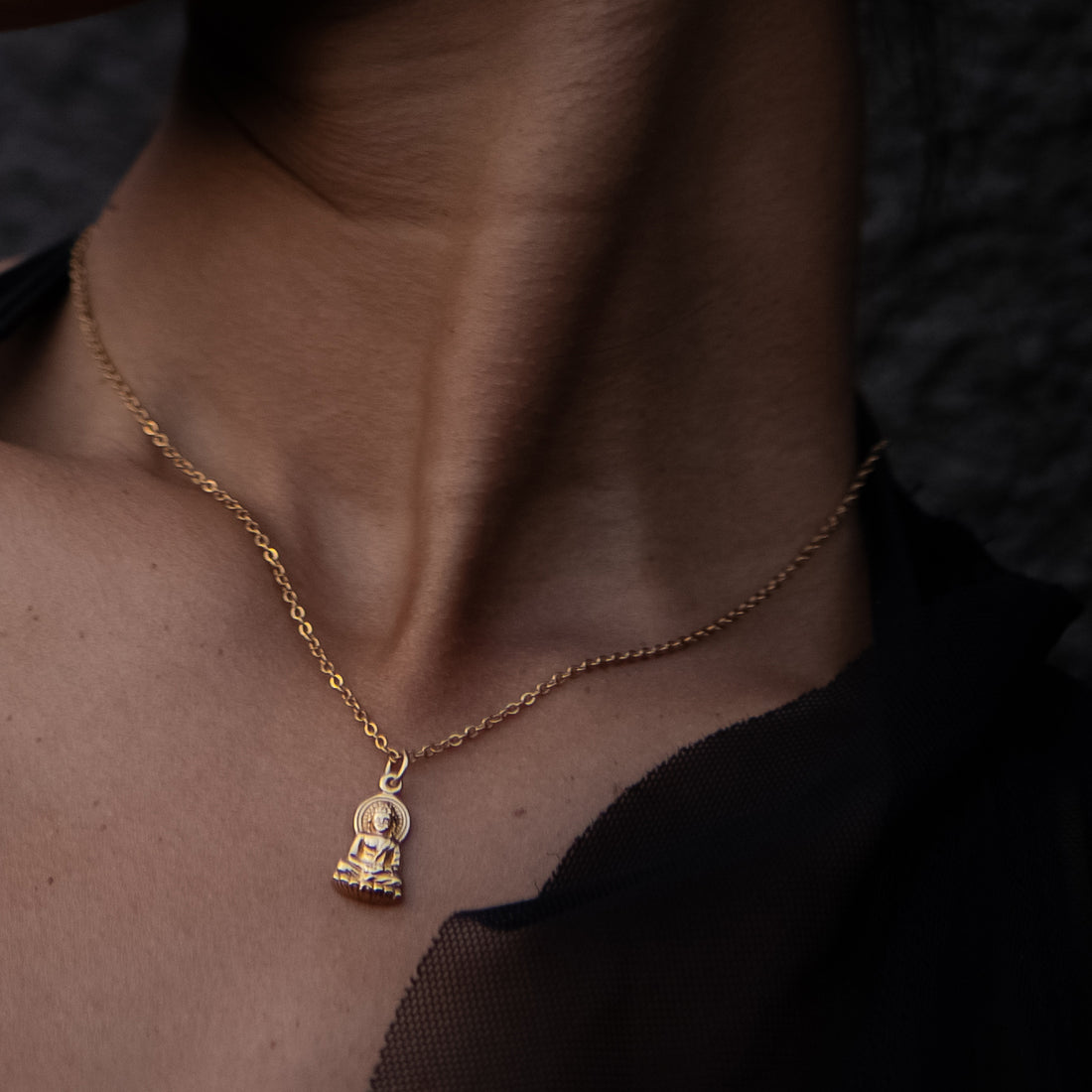 model wearing gold Buddha Charm