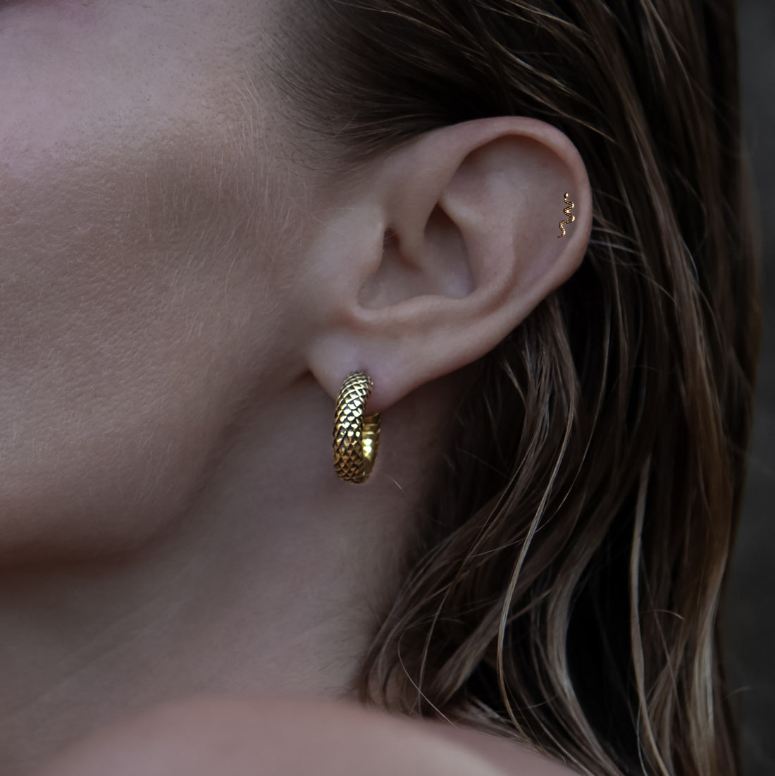 model wearing Rebirth Clicker Earrings