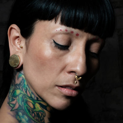 model wearing Scratched Brass Plugs