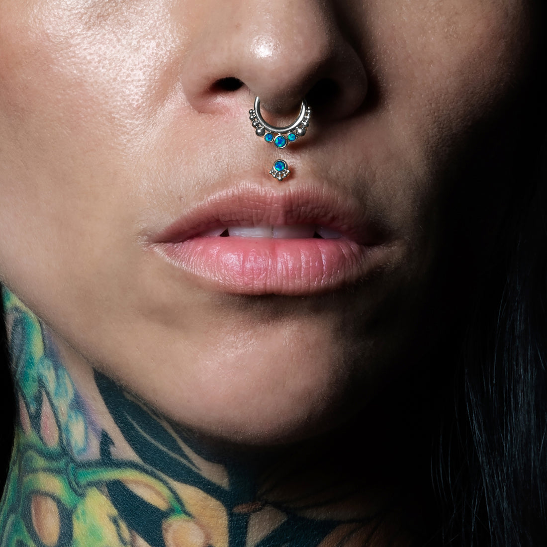 model wearing Siti Blue Opal Septum Clicker and Layla medusa Labret with Blue Opal