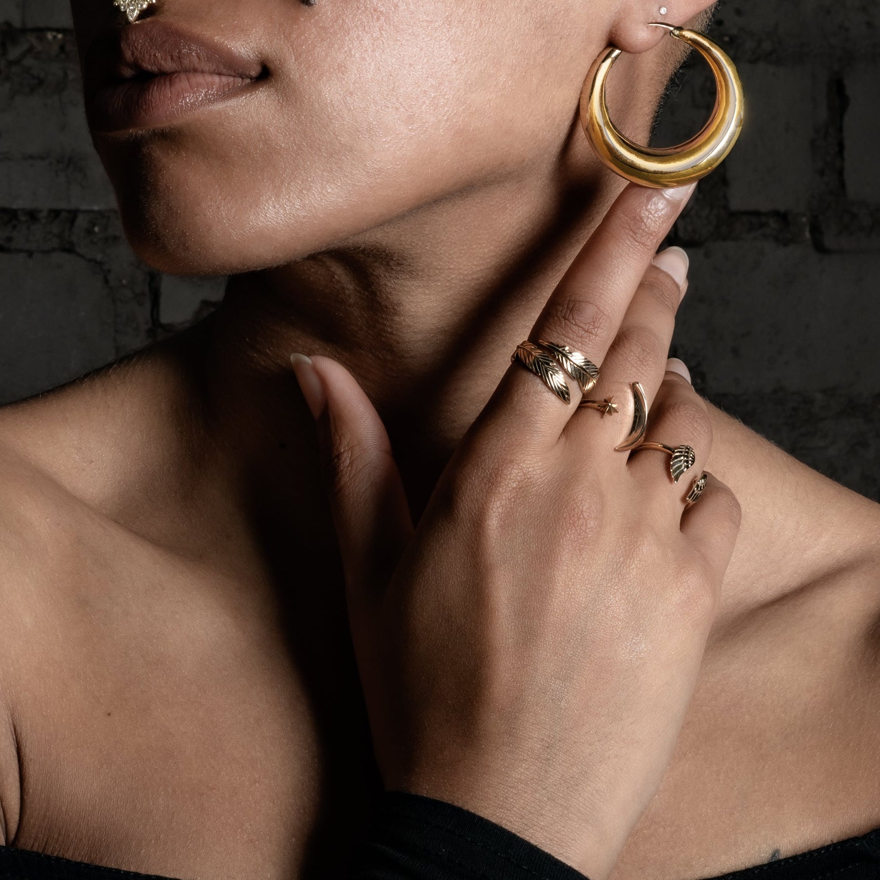 model wearing Open Feather Bronze Ring, Celestial ring, Wings ring and snake ring 