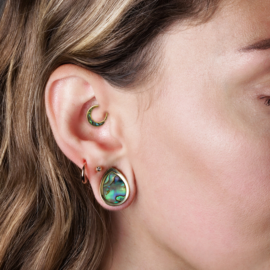model wearing Teardrop Plugs with Abalone