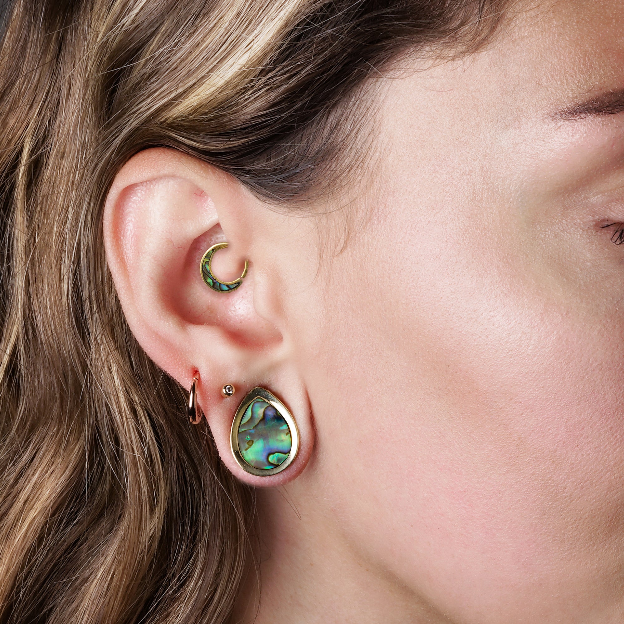 model wearing Teardrop Plugs with Abalone