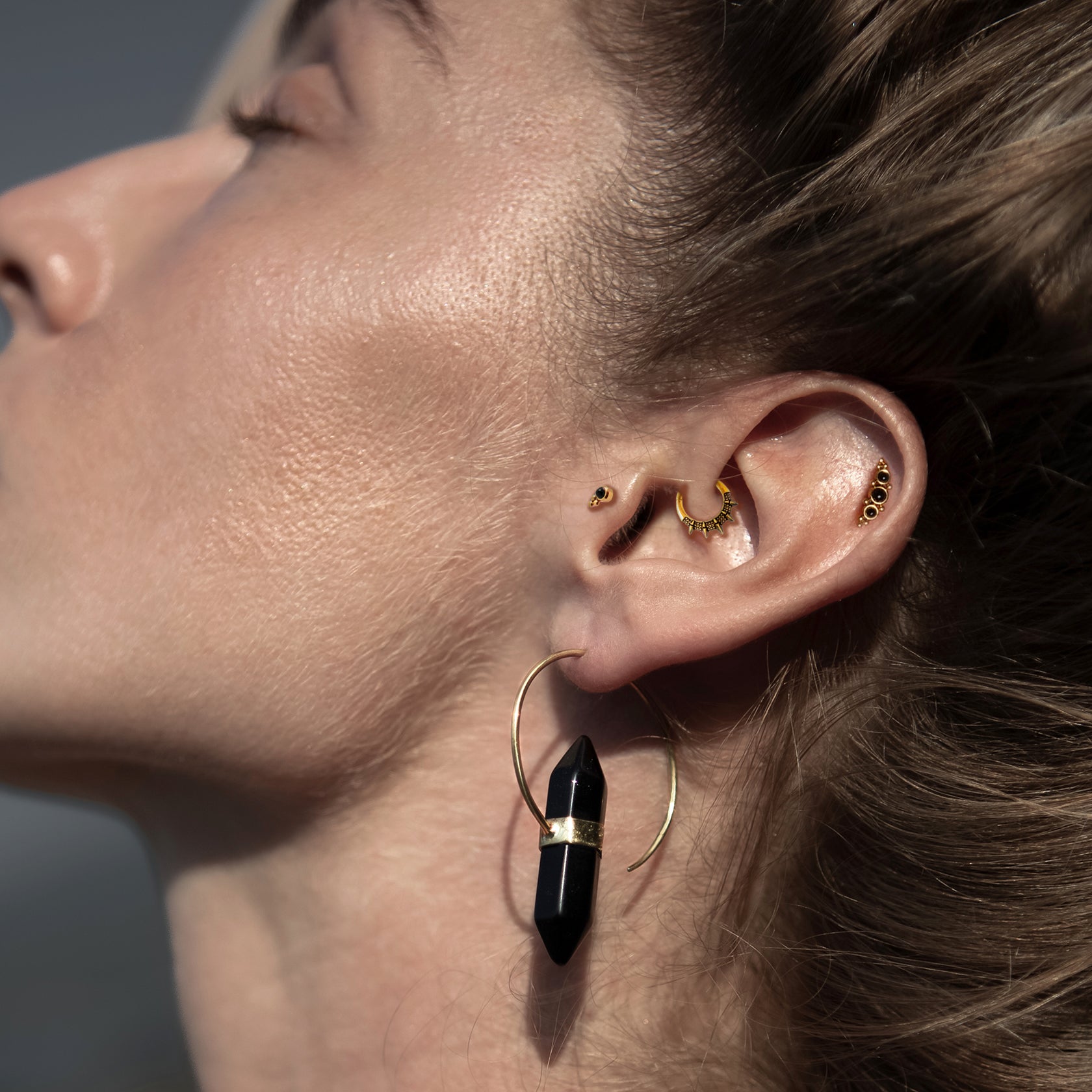 model wearing Golden Raja Spiky Septum on her daith