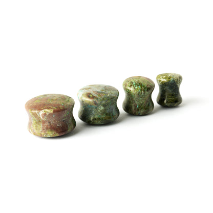 several sizes of African Green Jade double flare stone ear plugs front and side view