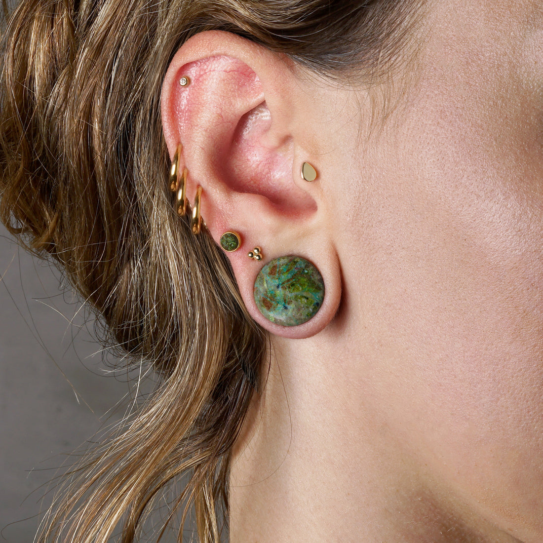model wearing African Green Jade double flare stone ear plug