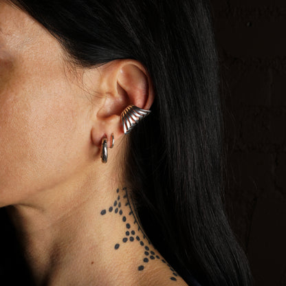 long ear cuff to cover your cartilage with multiple pointy rings model shoot