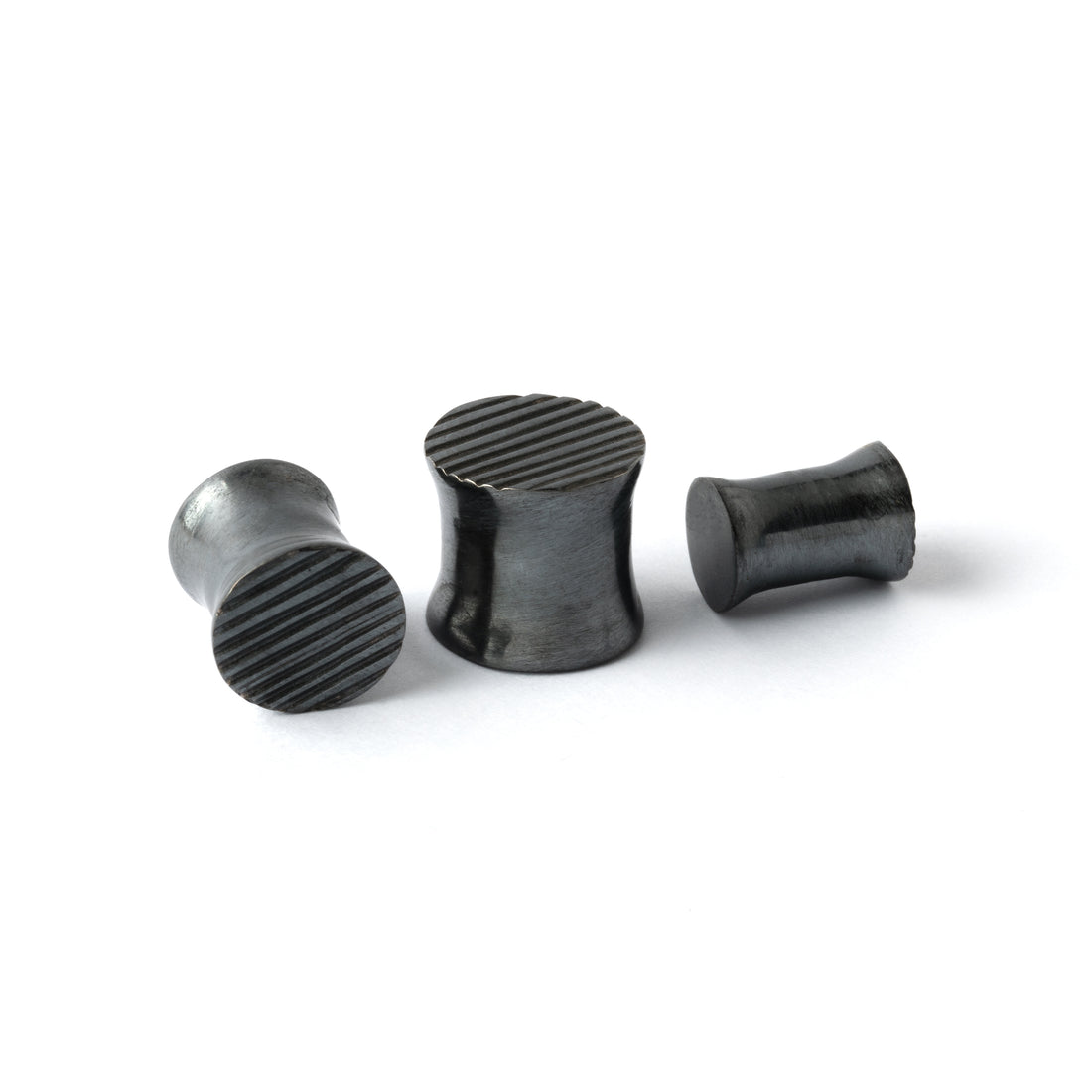 several sizes of double flared black silver scratched ear plugs front and side view