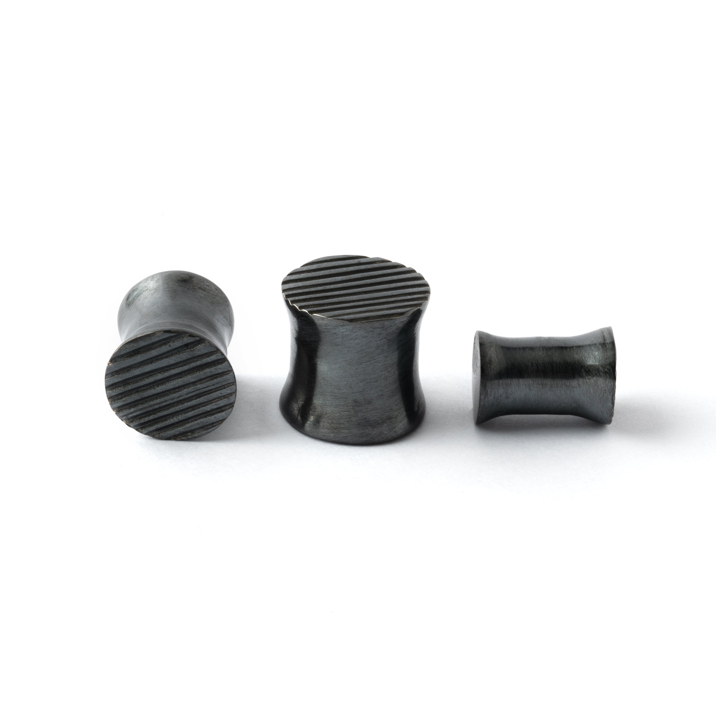 several sizes of double flared black silver scratched ear plugs front and side view