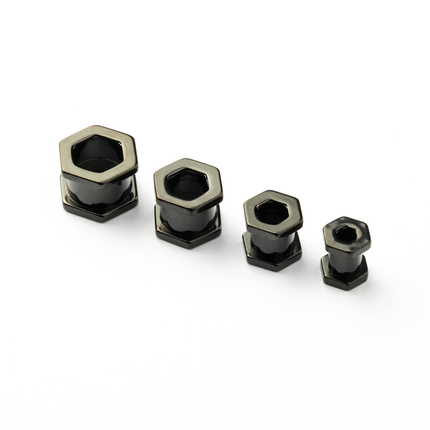 several sizes of surgical steel black hexagon ear tunnels front view