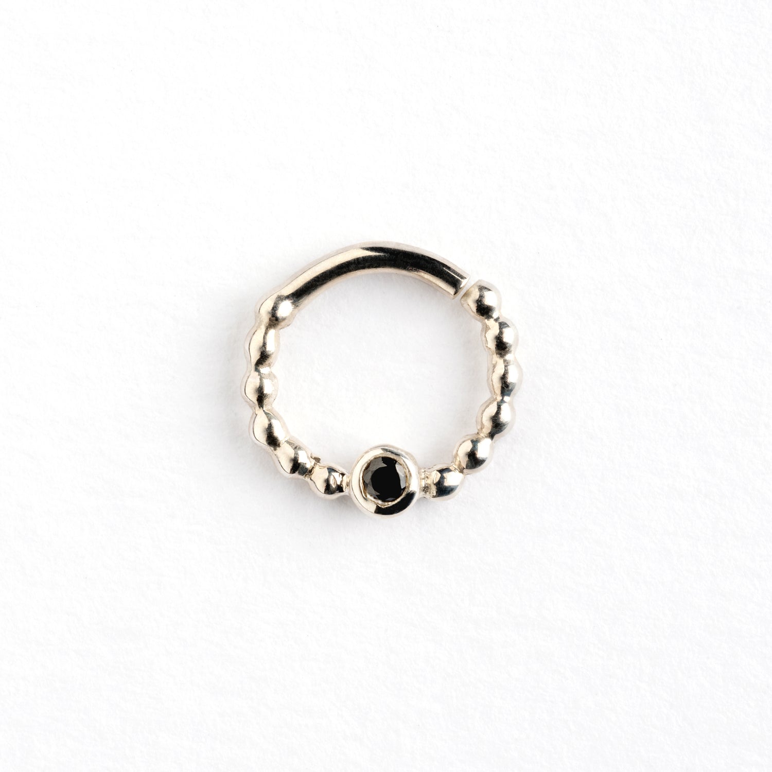 sterling silver dotted septum ring with black spinel gemstone frontal view