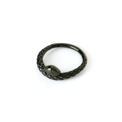 shiny black surgical steel snake piercing clicker ring left side view