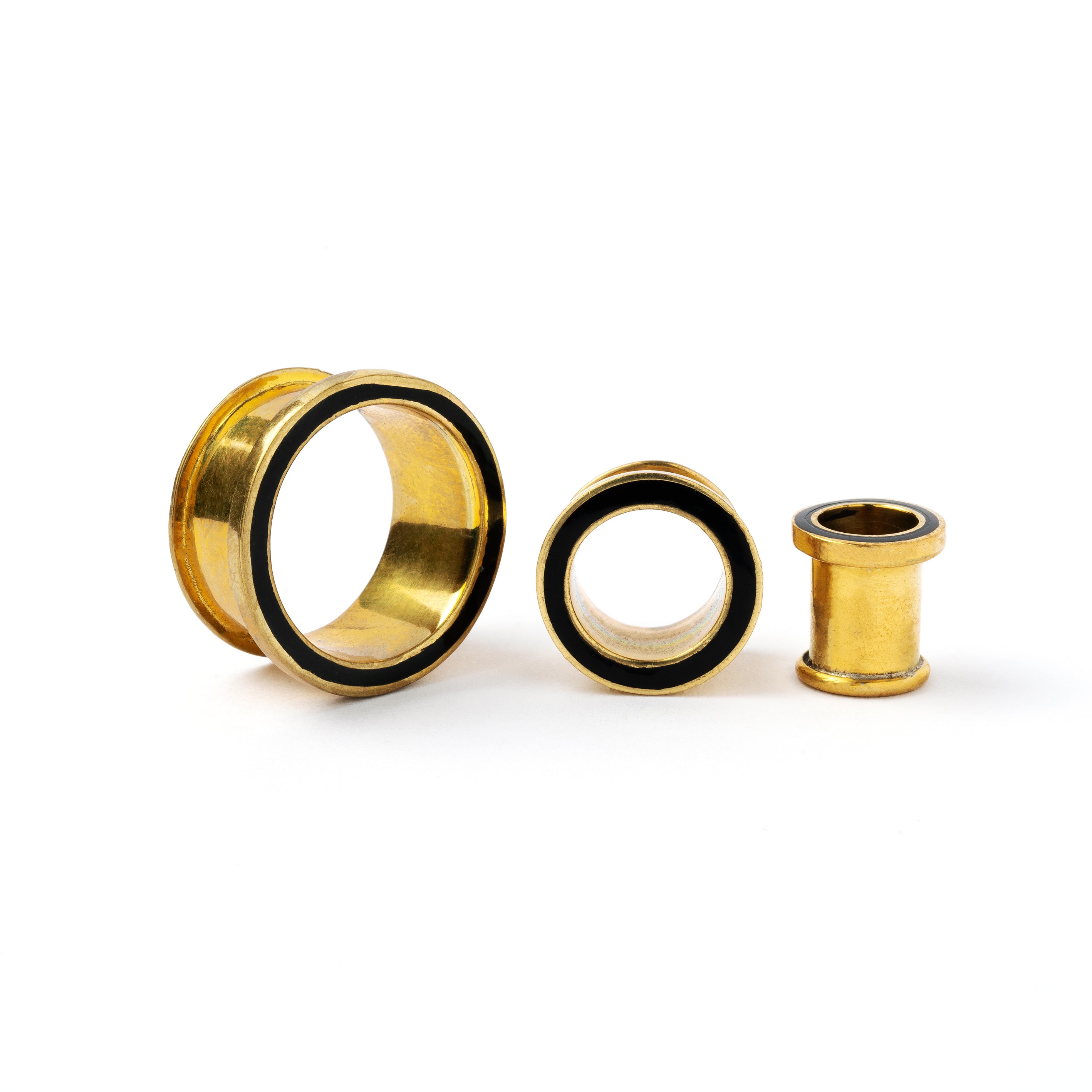 Golden brass plug tunnel with black resin inlay different sizes view