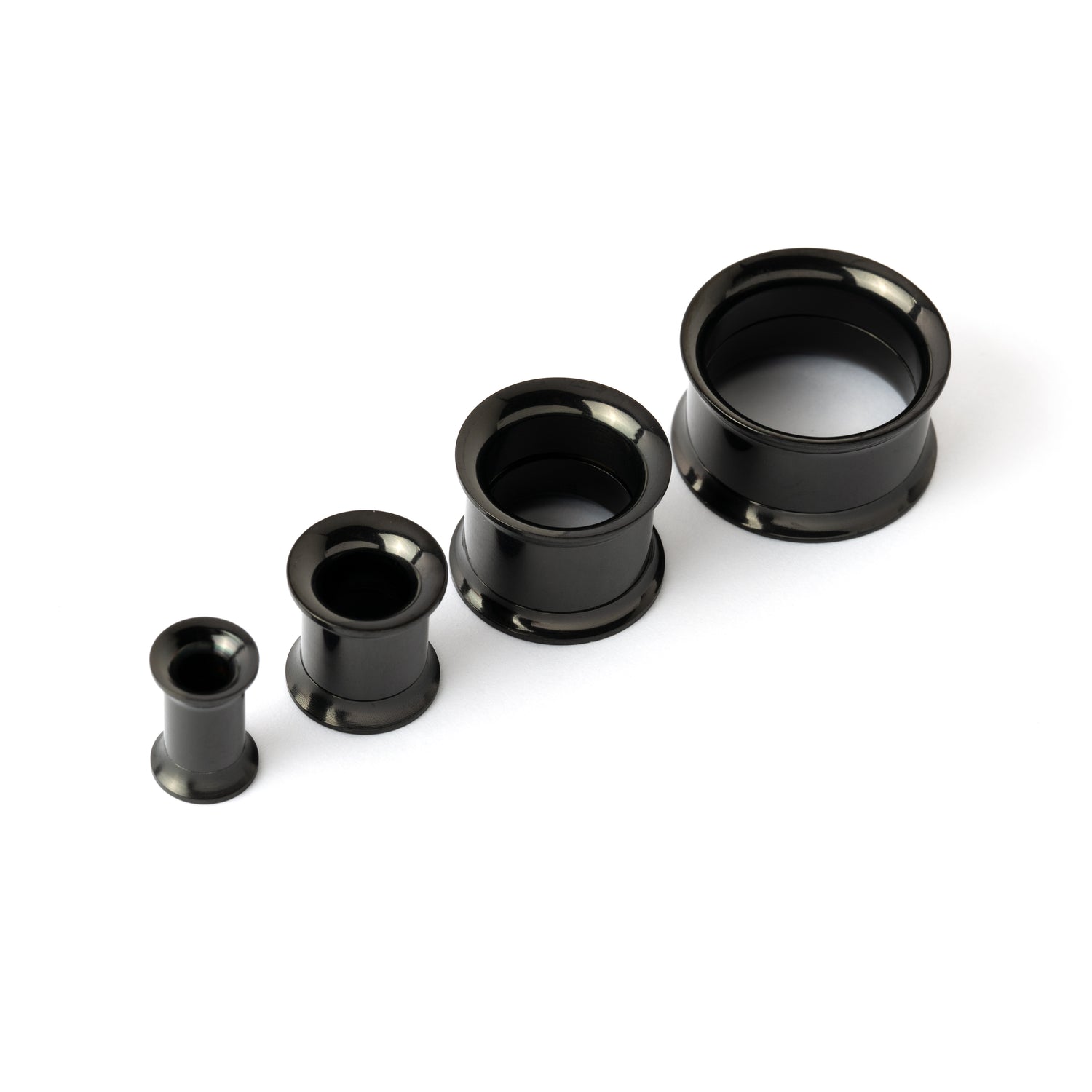 shiny black surgical steel plug tunnel in variety of sizes above view