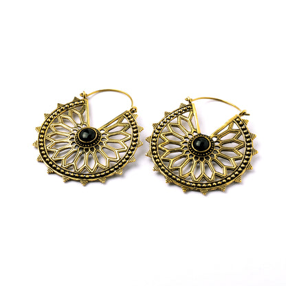 pair of golden brass geometric flower earrings with black onyx right side view