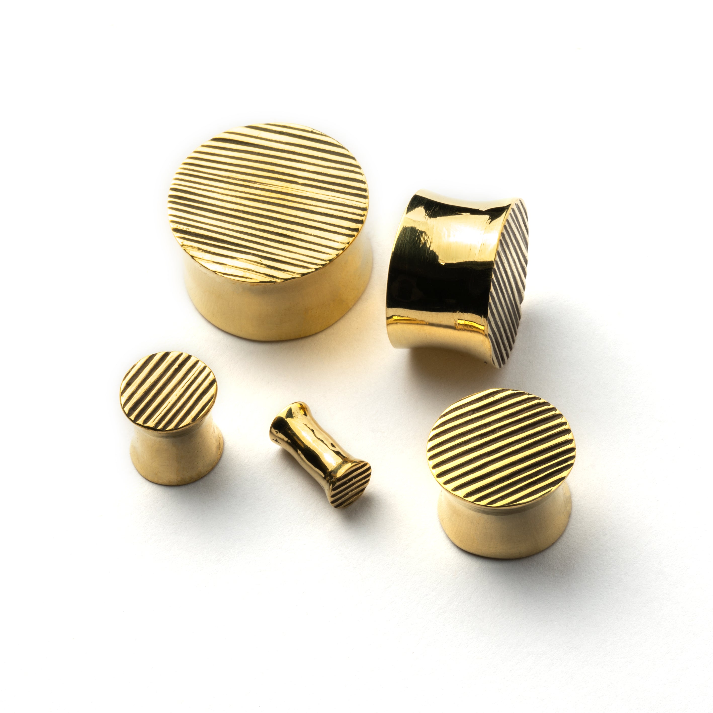 golden brass scratched plug earrings in different sizes