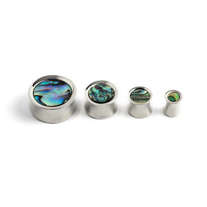 several sizes of silver ear plugs with abalone inlay front side view