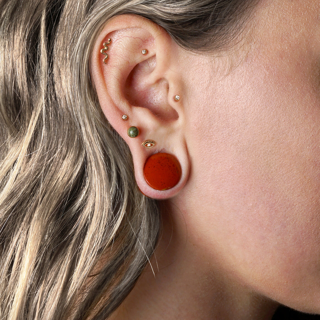 model wearing Brecciated Red Jasper double flare stone ear plug