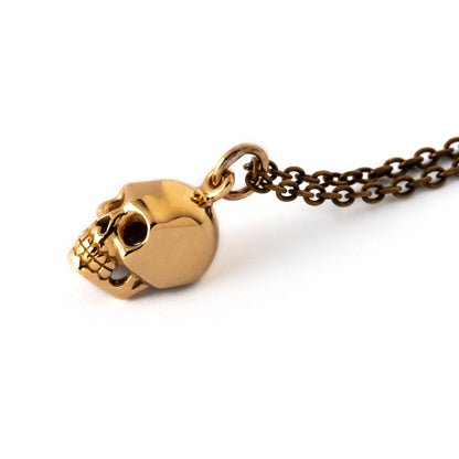 tiny bronze shiny skull pendant on a bronze chain necklace