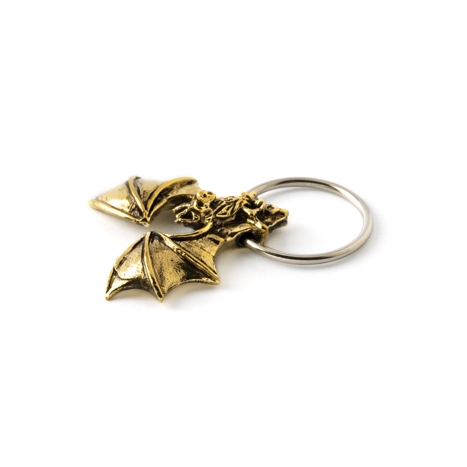 surgical steel piercing ring finely with detailed antique gold colour bat ornament close up view