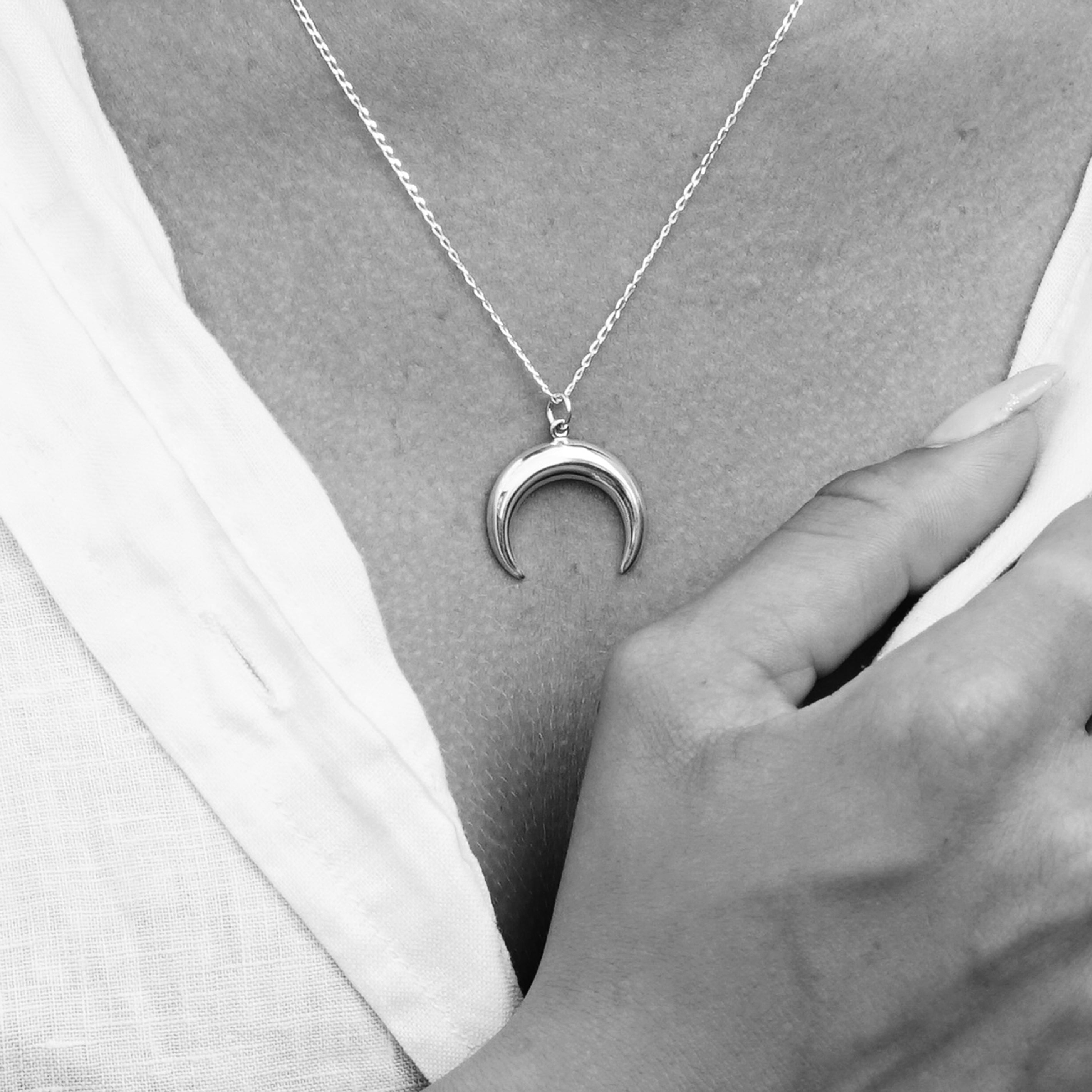 model wearing Silver crescent moon charm on a chain necklace