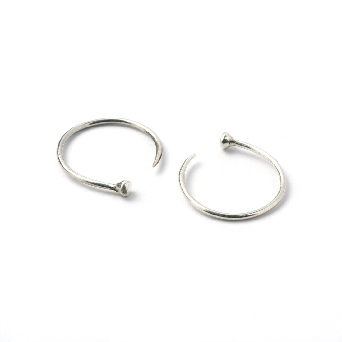 pair of open hoop silver wire earrings side and front view