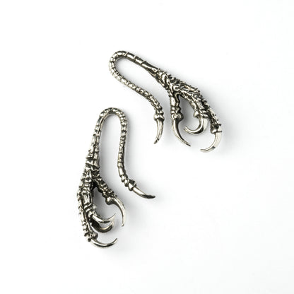 pair of silver brass dragon claw ear hangers left and right side view