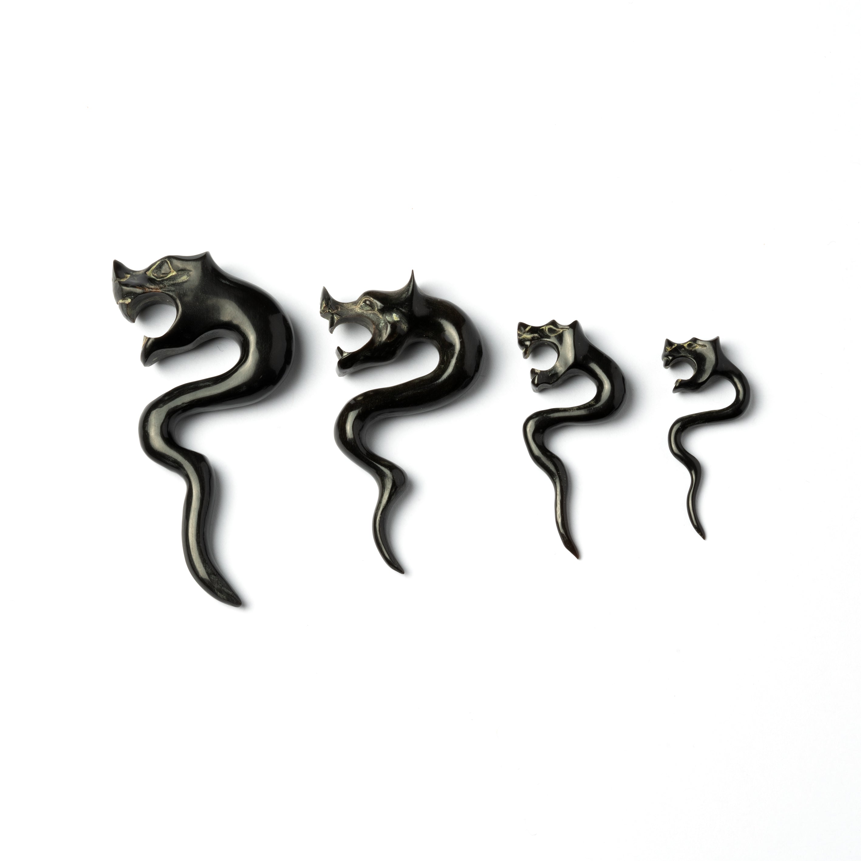several sizes of tiger head with zigzag hook ear stretchers side view