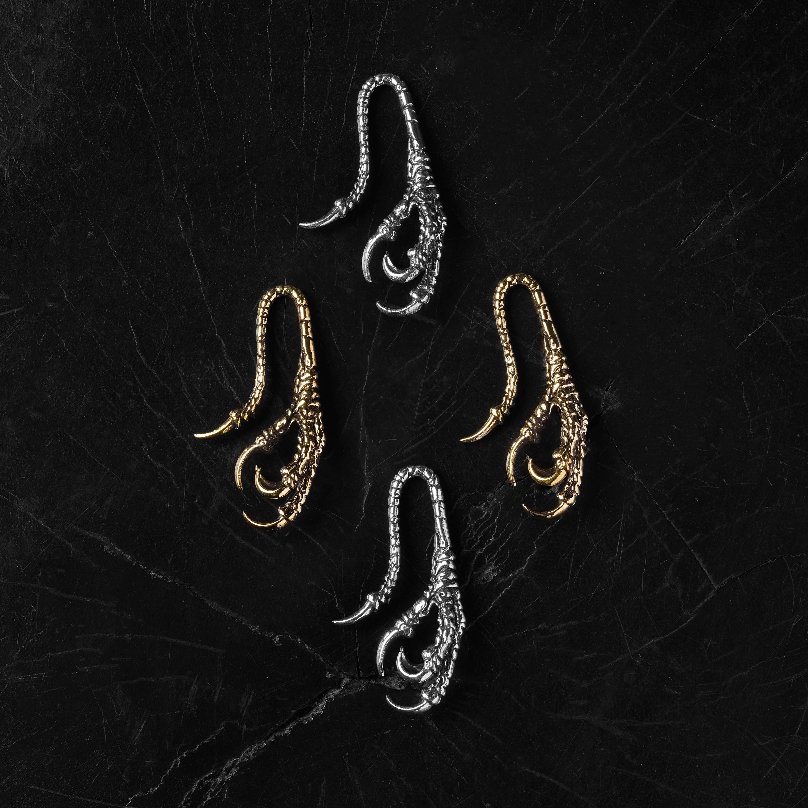 pair of silver and golden brass dragon claw ear hangers