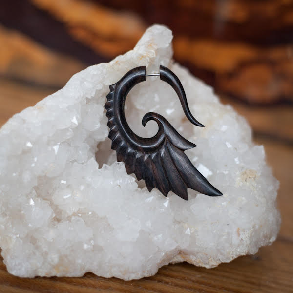 single wood wing shaped earring on a crystal stone