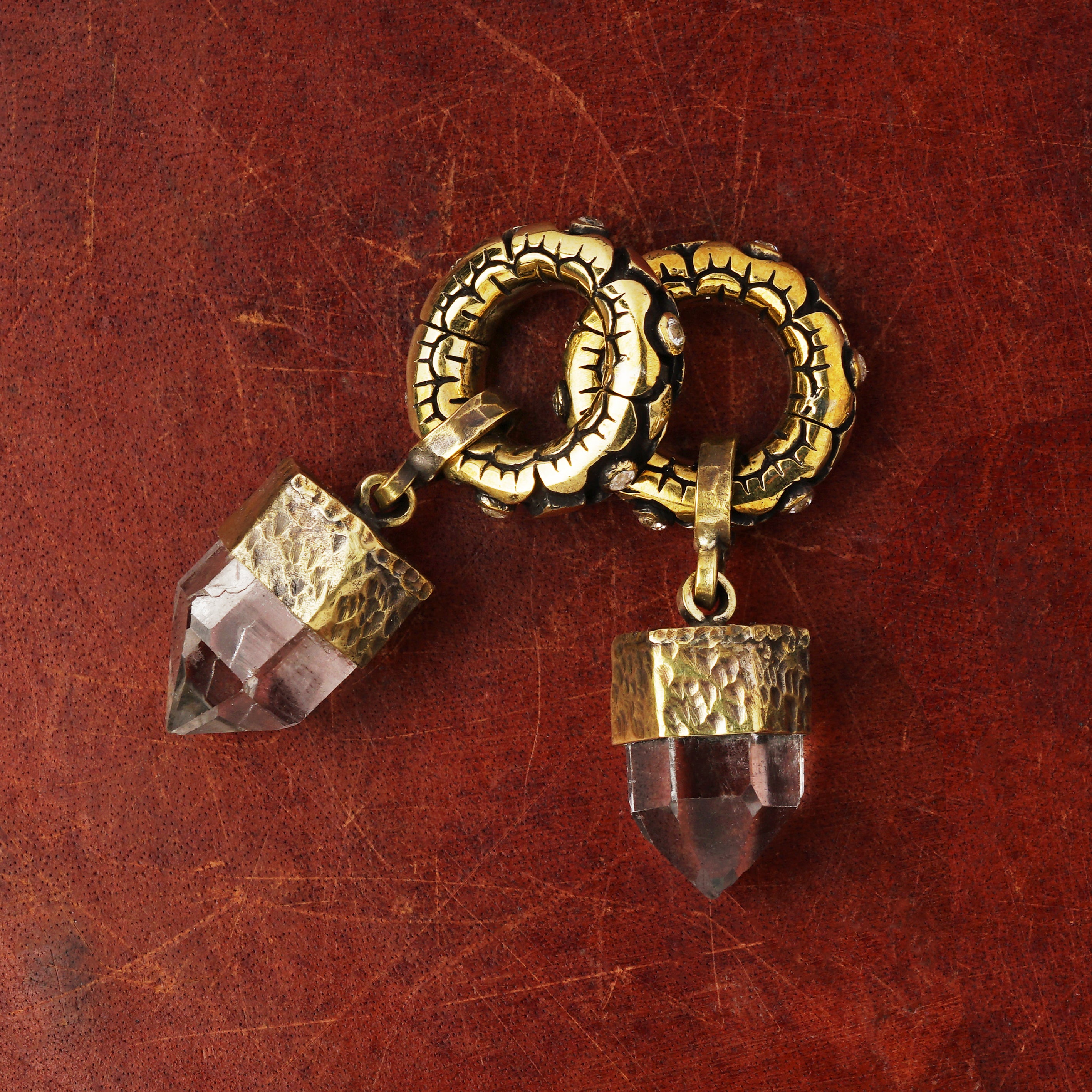 pair of golden flower hoops hangers for stretched ears with topaz stones and quartz pendant