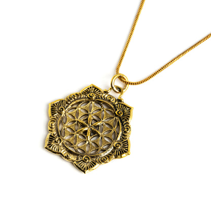 golden flower of life mandala pendant on a brass chain necklace left side view view