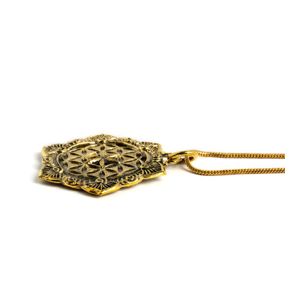 golden flower of life mandala pendant on a brass chain necklace side close up view