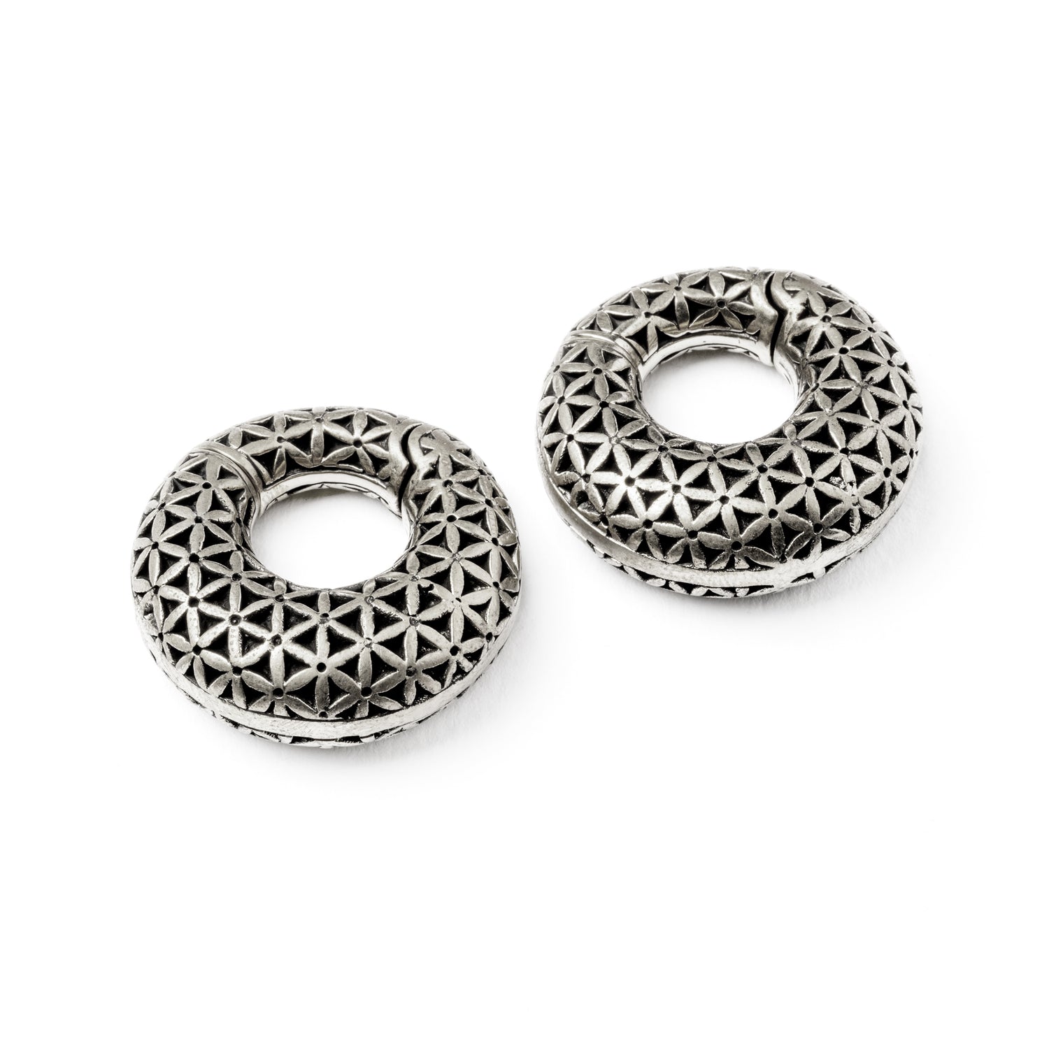 pair of silver brass ear weights hoops with flower of life pattern both sides view