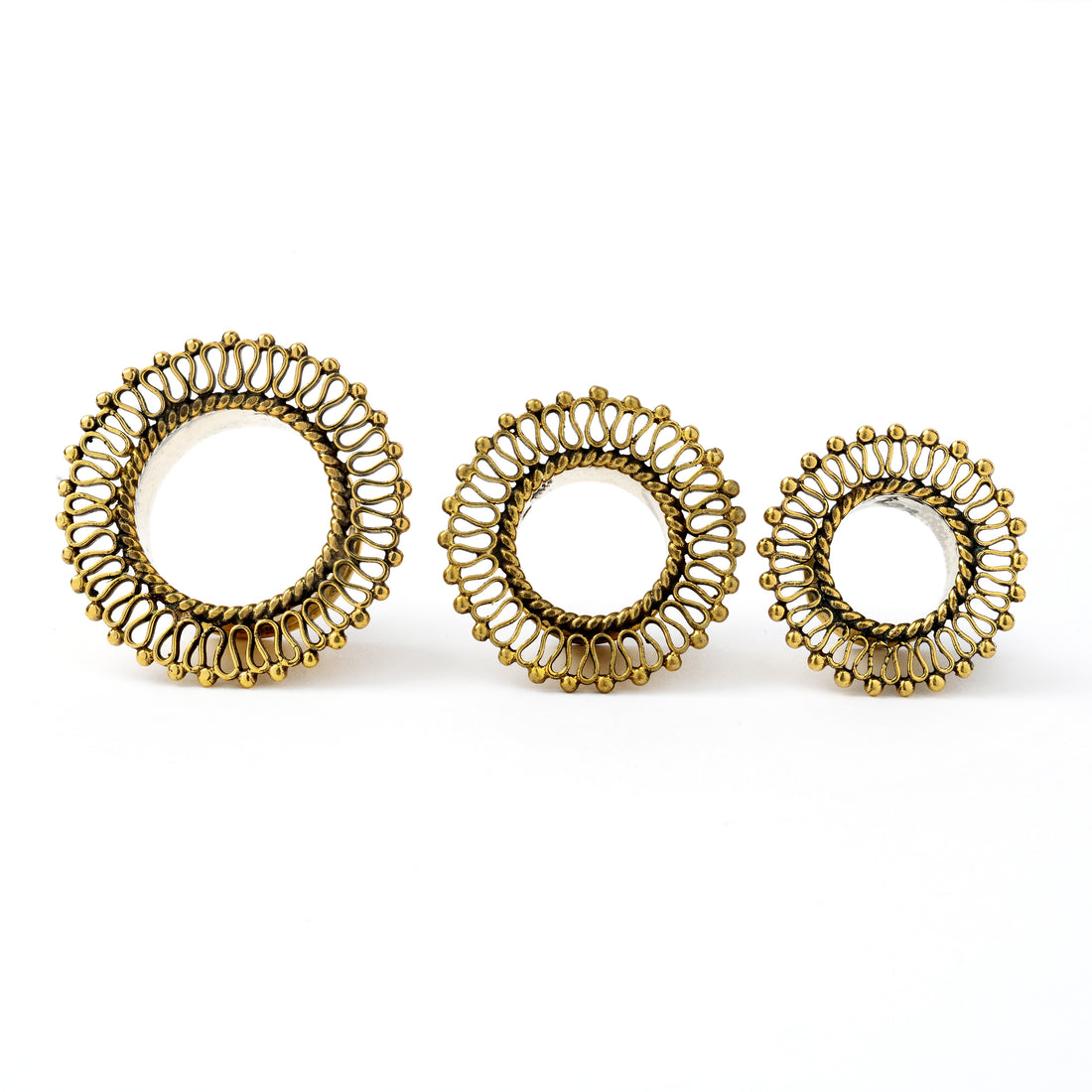 several sizes of golden brass filigree ear tunnels frontal view