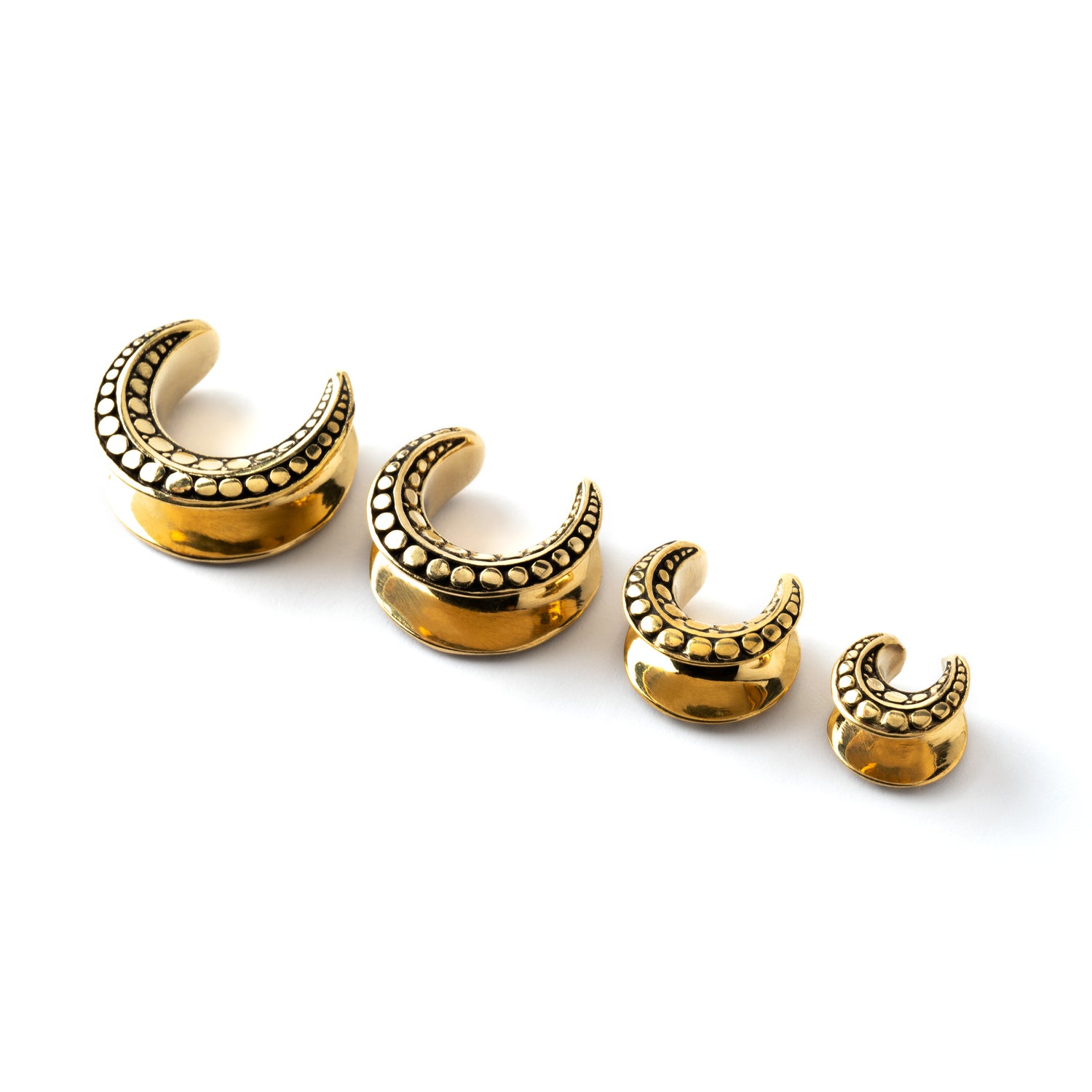 several sizes of Ada saddles ear tunnels side view