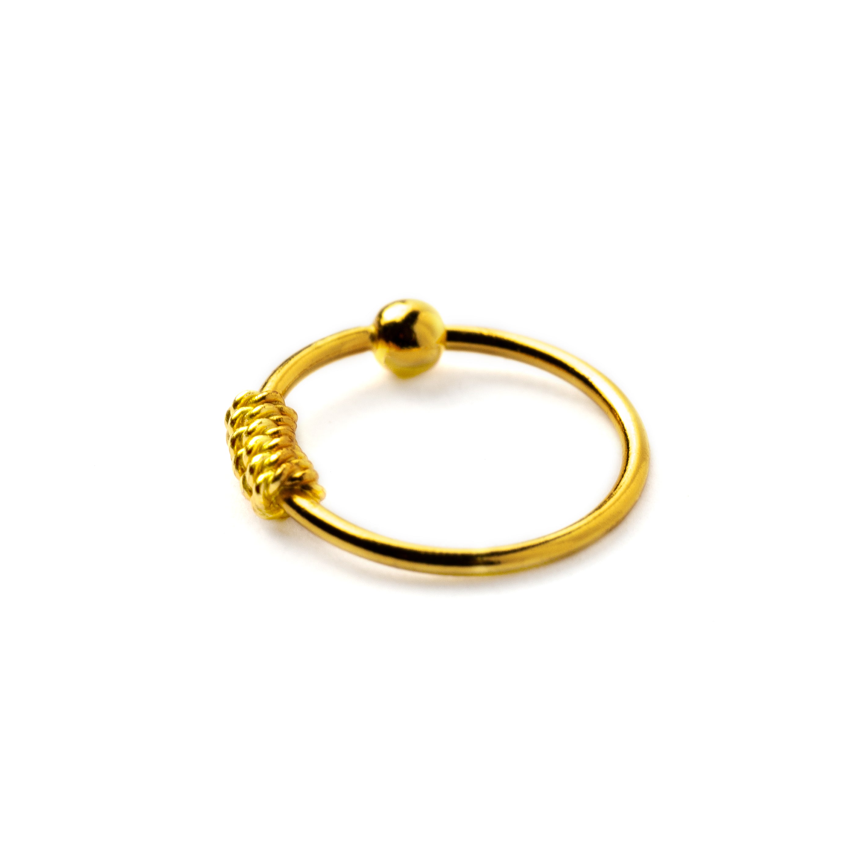 Gold coiled nose ring side view