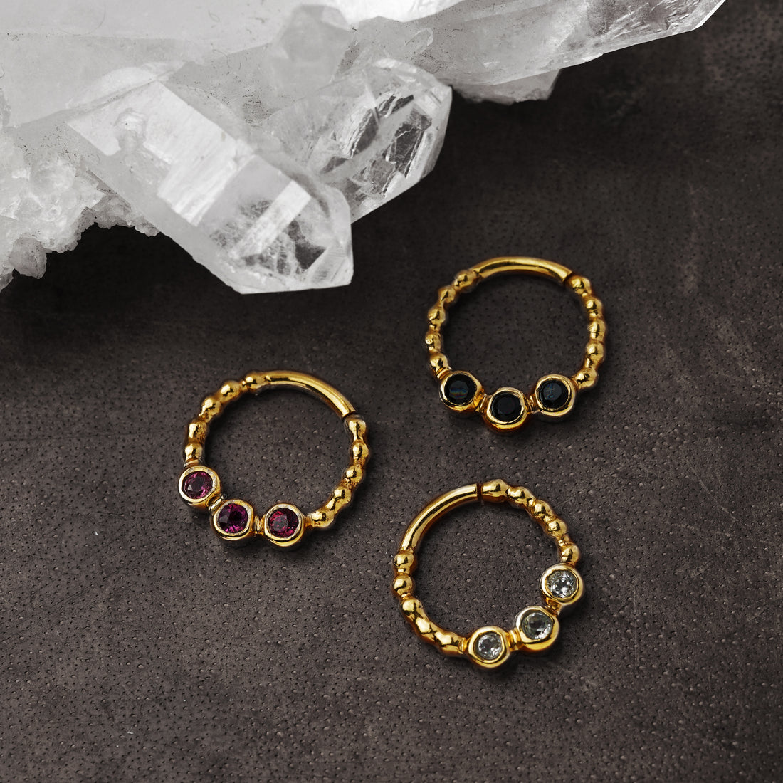 gold dotted septum ring with three Black Spinal, Ruby &amp; Topaz gemstones right side view