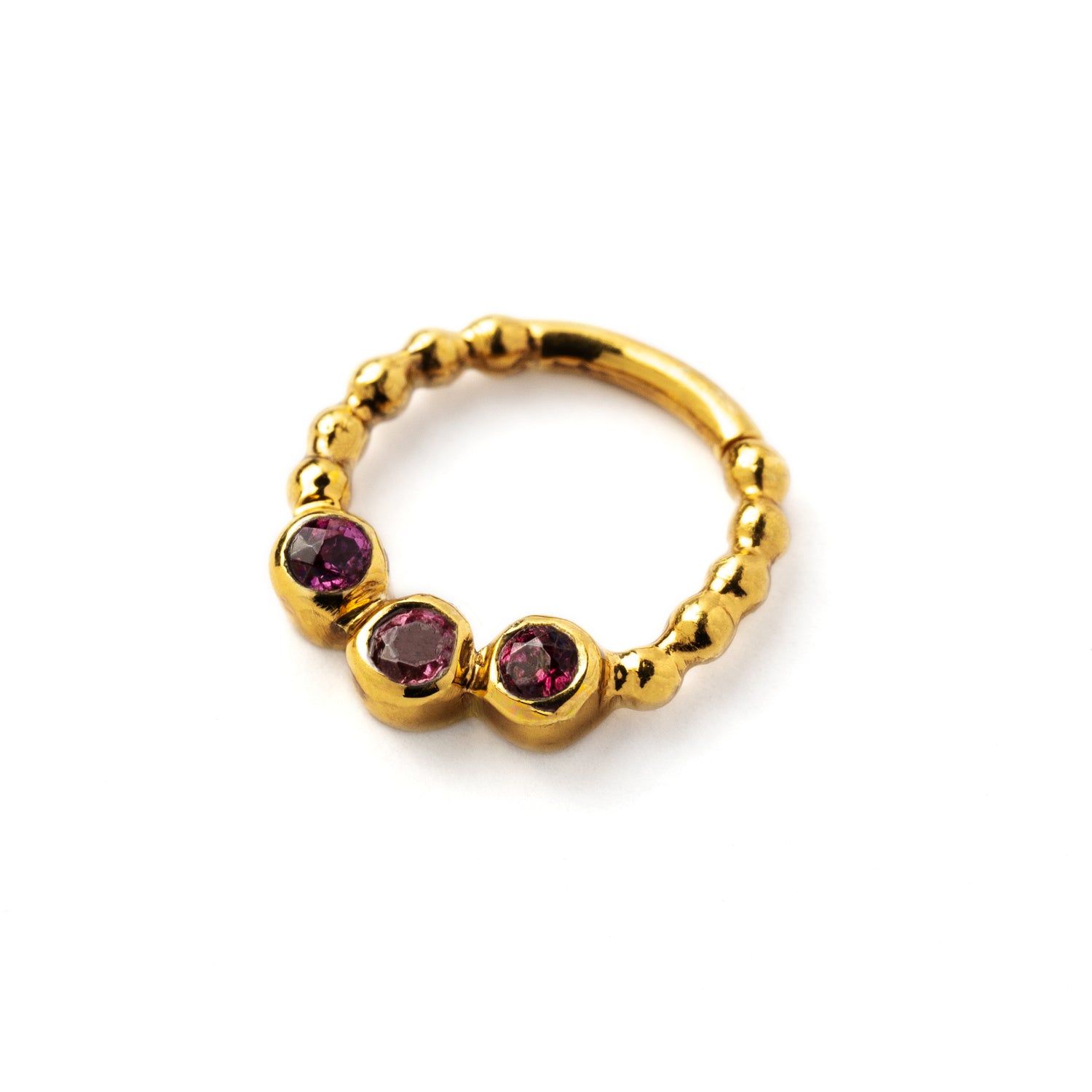 gold dotted septum ring with three Garnet gemstones left side view