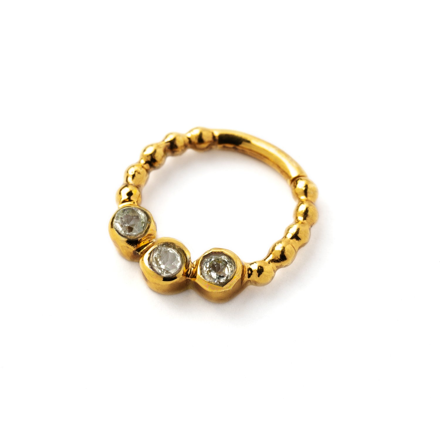 gold dotted septum ring with three White Topaz gemstones left side view