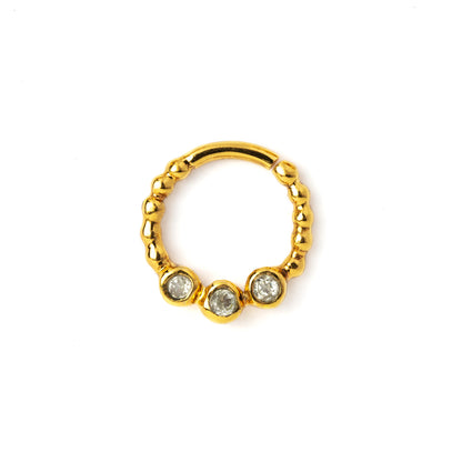 gold dotted septum ring with three White Topaz gemstones frontal view