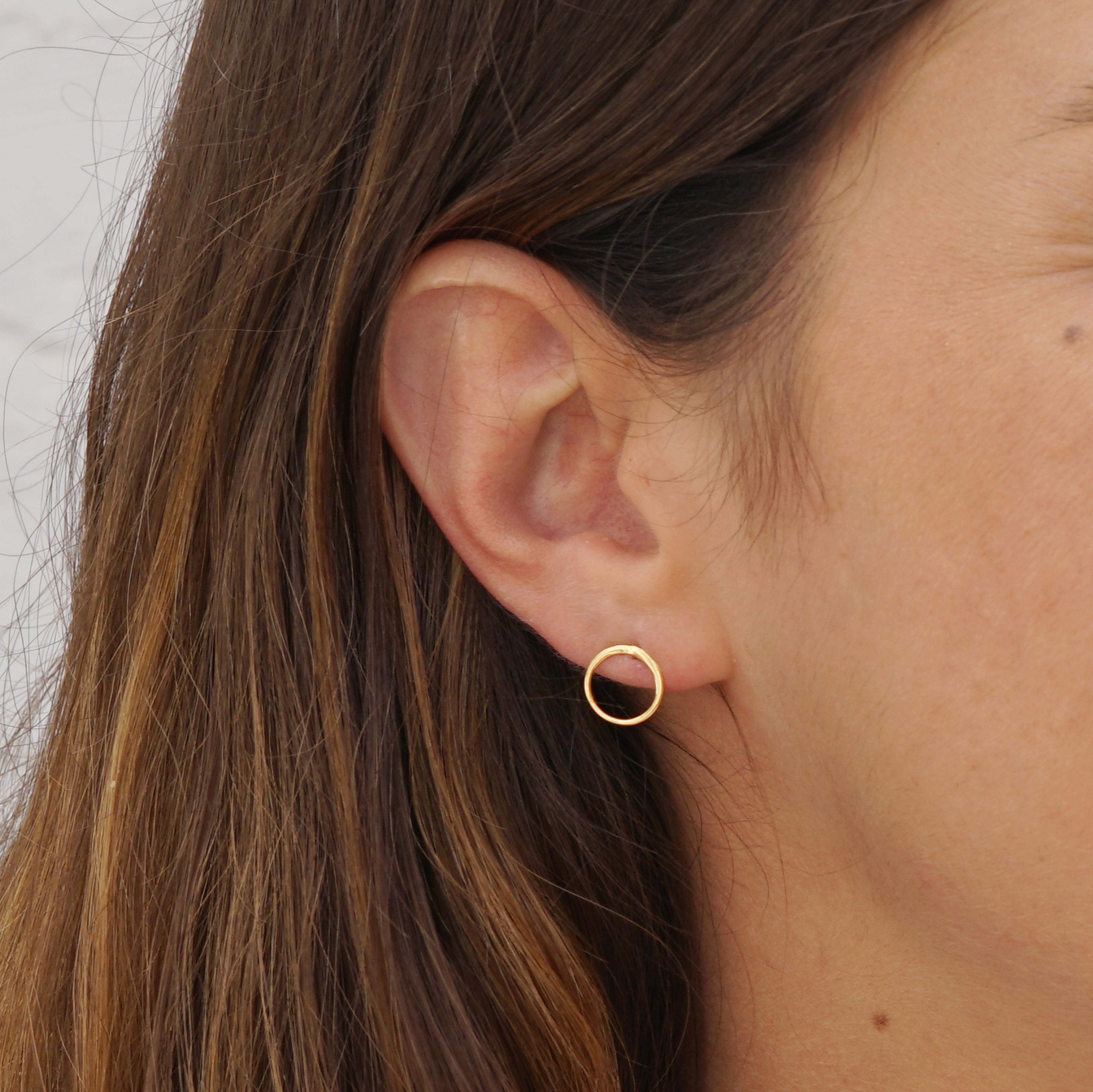 model wearing Gold circle ear studs 
