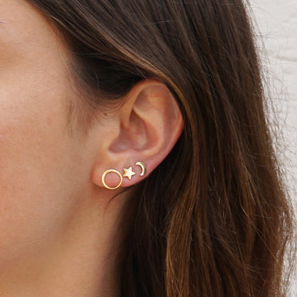 model wearing Gold celestial moon and star ear studs