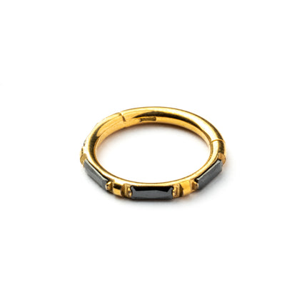 Gold septum clicker with black onyx stones around its rim frontal view