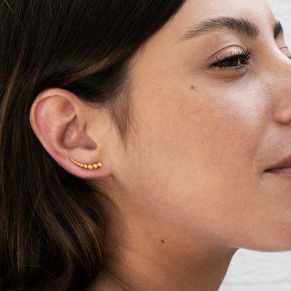 model wearing 24k gold plated silver multiple spheres ear climber