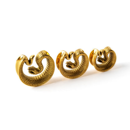 different sizes of golden surgical steel python snake plug tunnel