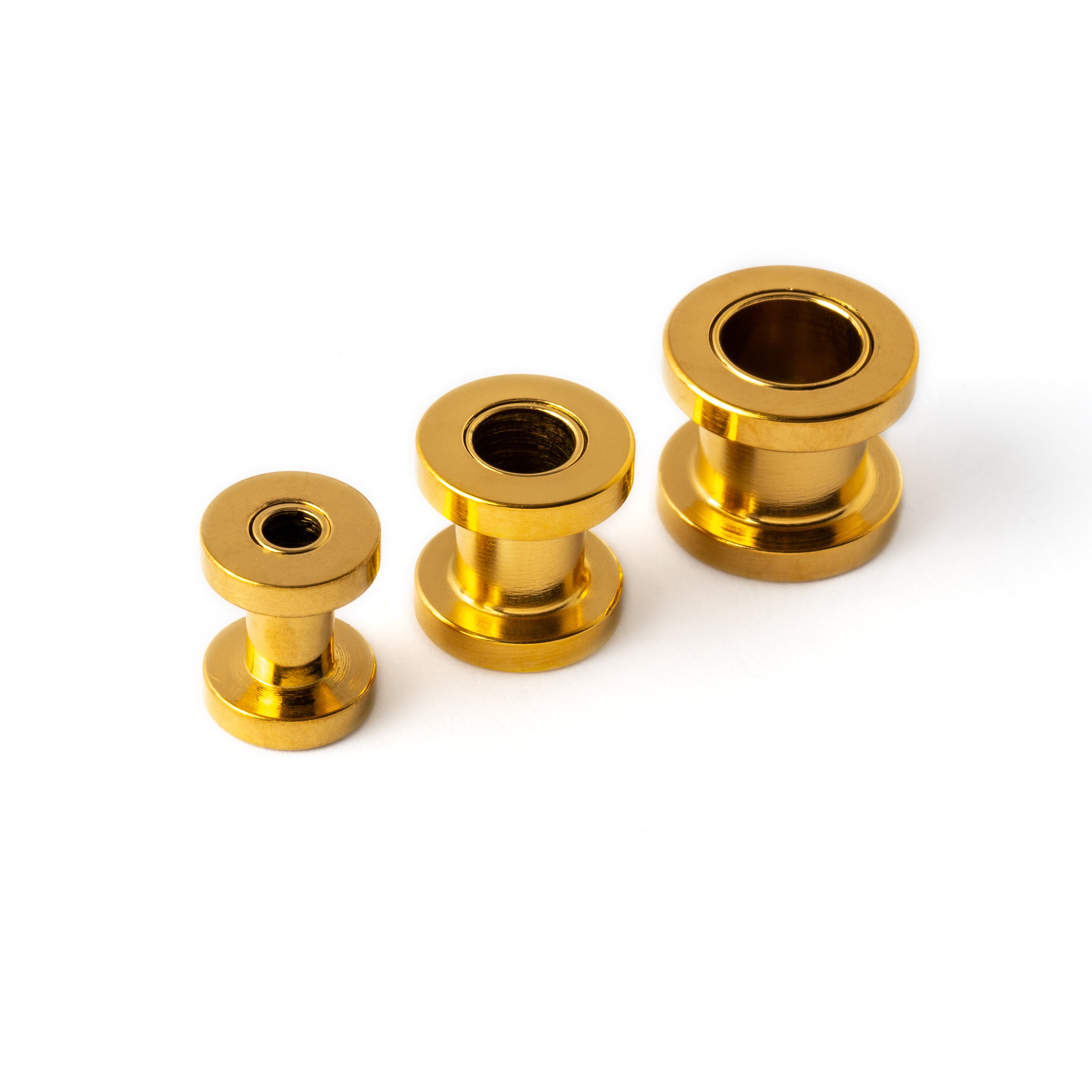 several sizes of golden surgical steel ear tunnels front view