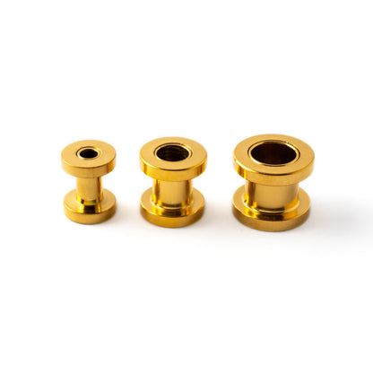 several sizes of golden surgical steel ear tunnels side view