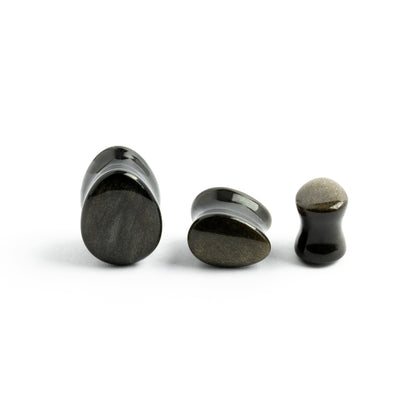 several sizes of Golden Obsidian teardrop plugs front and side view